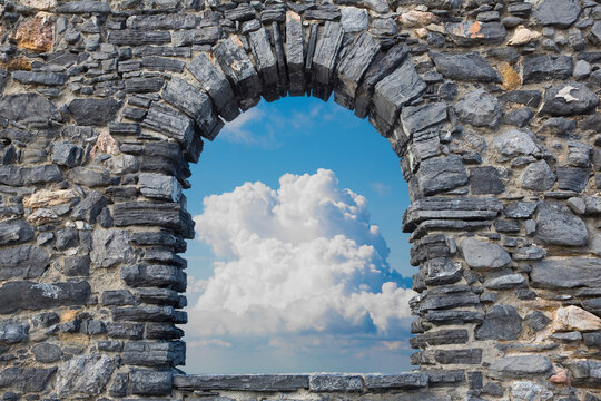 Cloudy sky view from an old stone window - freedom concept image