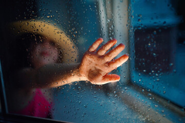 Fototapeta na wymiar a girl in a straw hat, rain outside the window. High quality photo