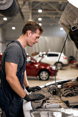 car mechanic in doing auto repair service and maintenance worker repairing vehicle. Service and...