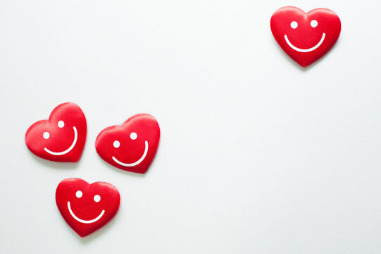 Valentine. Four red hearts with smile emoticons on white background. - Powered by Adobe