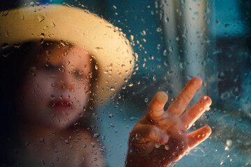 a girl in a straw hat, rain outside the window. High quality photo