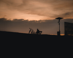 man and bicycle at sunset 