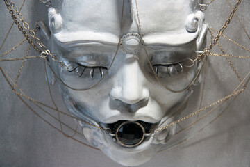 Black Jewel between the lips of the White Face. Sensual female Sculpture with metallic wires...