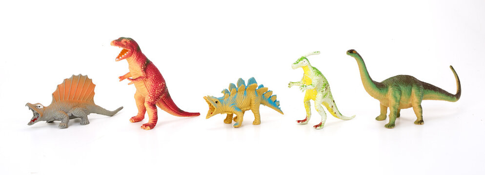 Various dinosaurs from prehistoric times in a row on white background.