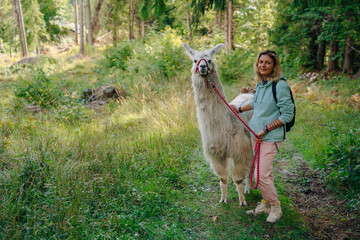 girl with a llama in the forest, italy © IBRESTER