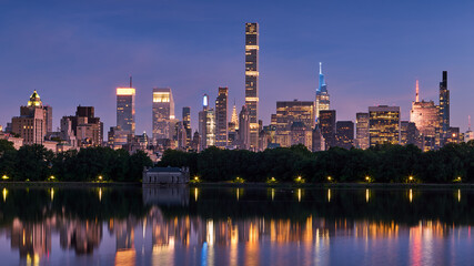 New York City skyline. Midtown Manhattan skyscrapers from Central Park Reservoir at Dusk. Evening...