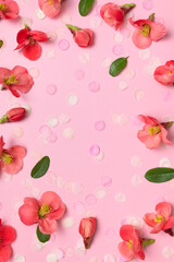 Spring background. Beautiful delicate fresh pink flowers and buds, paper confetti on pink background flat lay top view. Springtime nature concept. Bloom, inflorescence, flowering. Festive backdrop