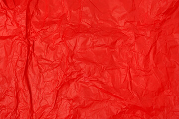 Crumpled paper background made from a blood red sheet of wrapping paper