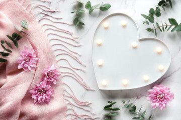 Heart shape lightbox. Winter flat lay with fragrant twigs and flowers on pink scarf. Wintertime...