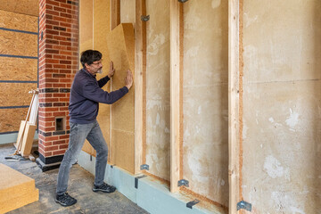 Installing thermal insulation inside a building, wood fiber boards  - 484192098
