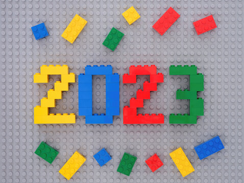Tambov, Russian Federation - July 22, 2021 Lego numbers 2023 and some Lego bricks on gray baseplate background. New Year concept.
