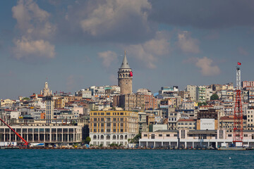 Fototapeta na wymiar Cityscape with sea and houses on the shore, old tower and sights. Golden Horn Bay, Galata Tower. Istanbul, Turkey. Journey, sights