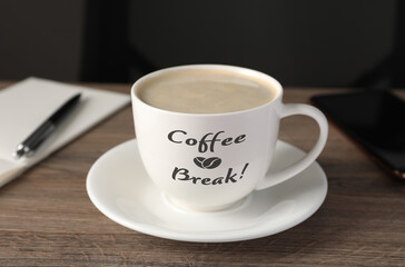 Fototapeta na wymiar Cup with inscription Coffee Break on wooden table in office