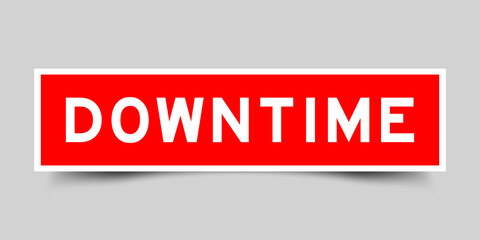 Sticker label with word downtime in red color on gray background