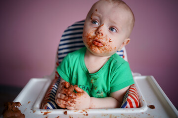 baby stained in chocolate. High quality photo