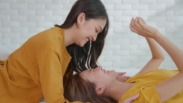Asian homosexual women bump their noses together They tease each other happily in bed morning. Lesbian, gay and bisexual liberties, two girls playing together. Transgender couples offer about LGBTQ+.