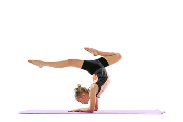 One flexible young girl, rhythmic gymnastics artist practicing isolated on white studio background. Grace in motion, action. Doing exercises in flexibility.