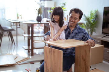 fahter and daughter Putting Together Self Assembly Furniture
