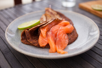 salted salmon fillet with rye pancakes and lime