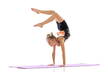 One flexible young girl, rhythmic gymnastics artist practicing isolated on white studio background....