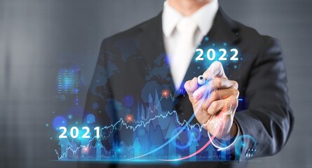 Businessman or trader showing glowing virtual technical investment graph chart for analysis stock...