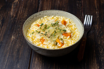 Risotto with pumpkin, cheese and thyme. Vegetarian food. Healthy eating.