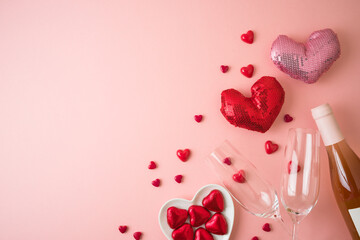 Valentines day background with heart shapes, chocolates and wine bottle. Top view with copy space