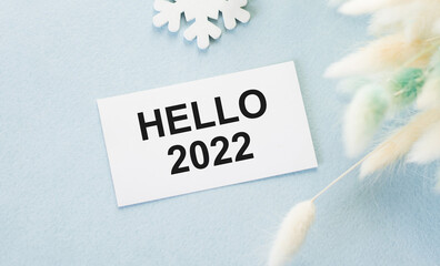 a card with text hello 2022 on a blue background, the beginning of a new year, plans and ideas