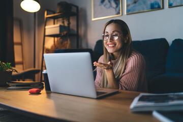 European girl having video call on laptop at home