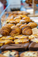 Pile of croissant and pastry for sale at patisserie store