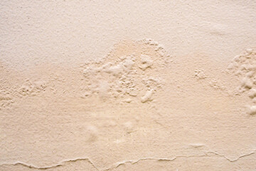 Fototapeta na wymiar Brown wall damp damaged with peeling paint