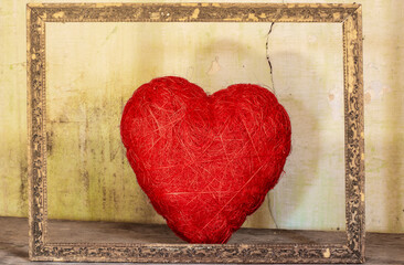 a heart of love in an ancient frame forgotten in an attic