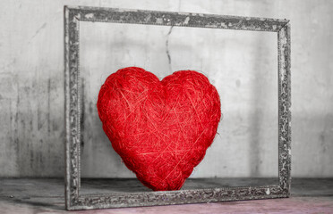 an old red heart of passion in an Ancient frame