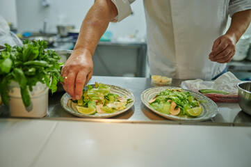 Cook prepares salad