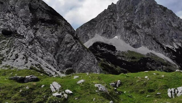Aerial of Austrian Alps Drachensee mountain rolling over hill
