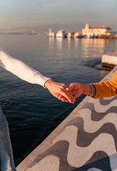 Hands of couple in love on the background of the embankment in Izmir 