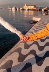 Hands of a couple in love on the background of the embankment in Izmir 