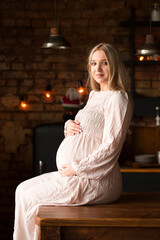 Fototapeta na wymiar Pregnant woman in the kitchen