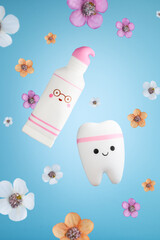 Funny toothpaste and tooth with flowers on a blue background. Dental concept. Stomatology. Summer spring postcard. Selective focus