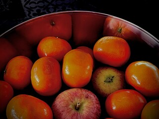 A bowl of mandarins and apples