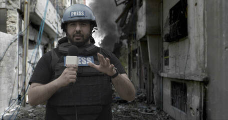 POV Camera view, War journalist correspondent wearing bulletproof vest and helmet reporting live...