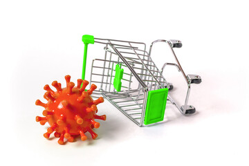 Coronavirus next to an overturned grocery cart. The concept of declining sales and business...