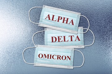Blue medical face masks for protection against Covid-19 with text inscriptions Alpha Delta omicron...