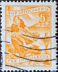Yugoslavia - circa 1952 : a postage stamp from Yugoslavia, showing two Fishery
