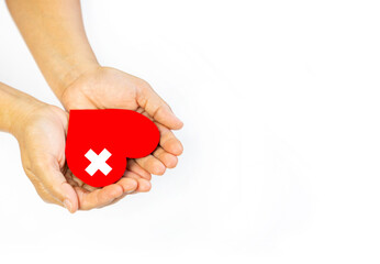 Hand holding red heart on isolate whtie background.