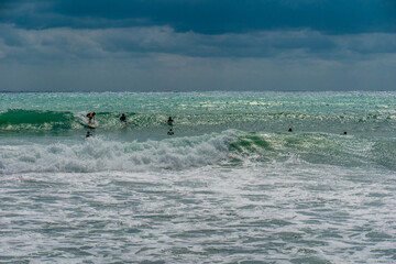 Surfing on the waves in the sea during a storm