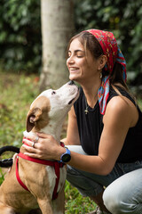 A young woman with a Pitbull mix