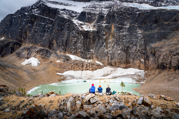 A single mother and her two children overlooking a melting glacier at Edith Cavell Meadows Jasper National Park Canada