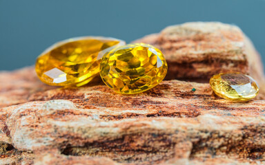 Natural Sapphire gemstone, Jewel or gems on black shine color, natural yellow gemstones on stone