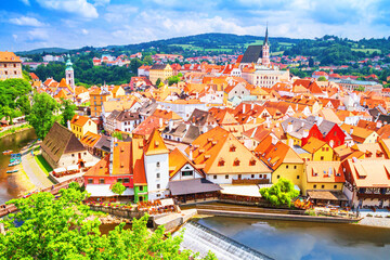 Naklejka premium Summer cityscape - top view of the Old Town of Cesky Krumlov and the Vltava river flowing through it, Czech Republic